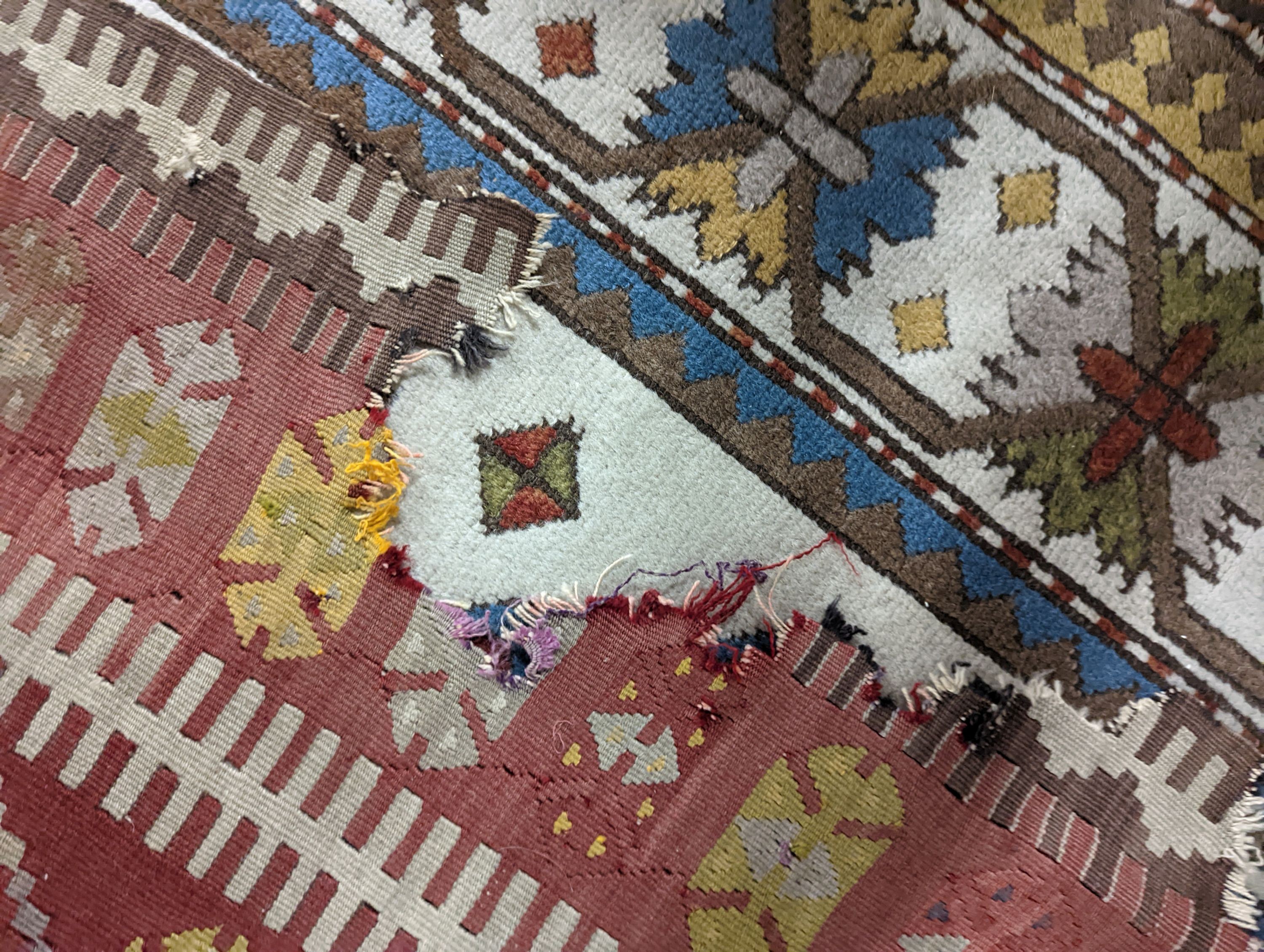 A Kilim polychrome flatweave runner, 380 x 118cm (holed)